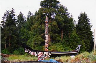 Kay Llnagaay poles and Haida canoe